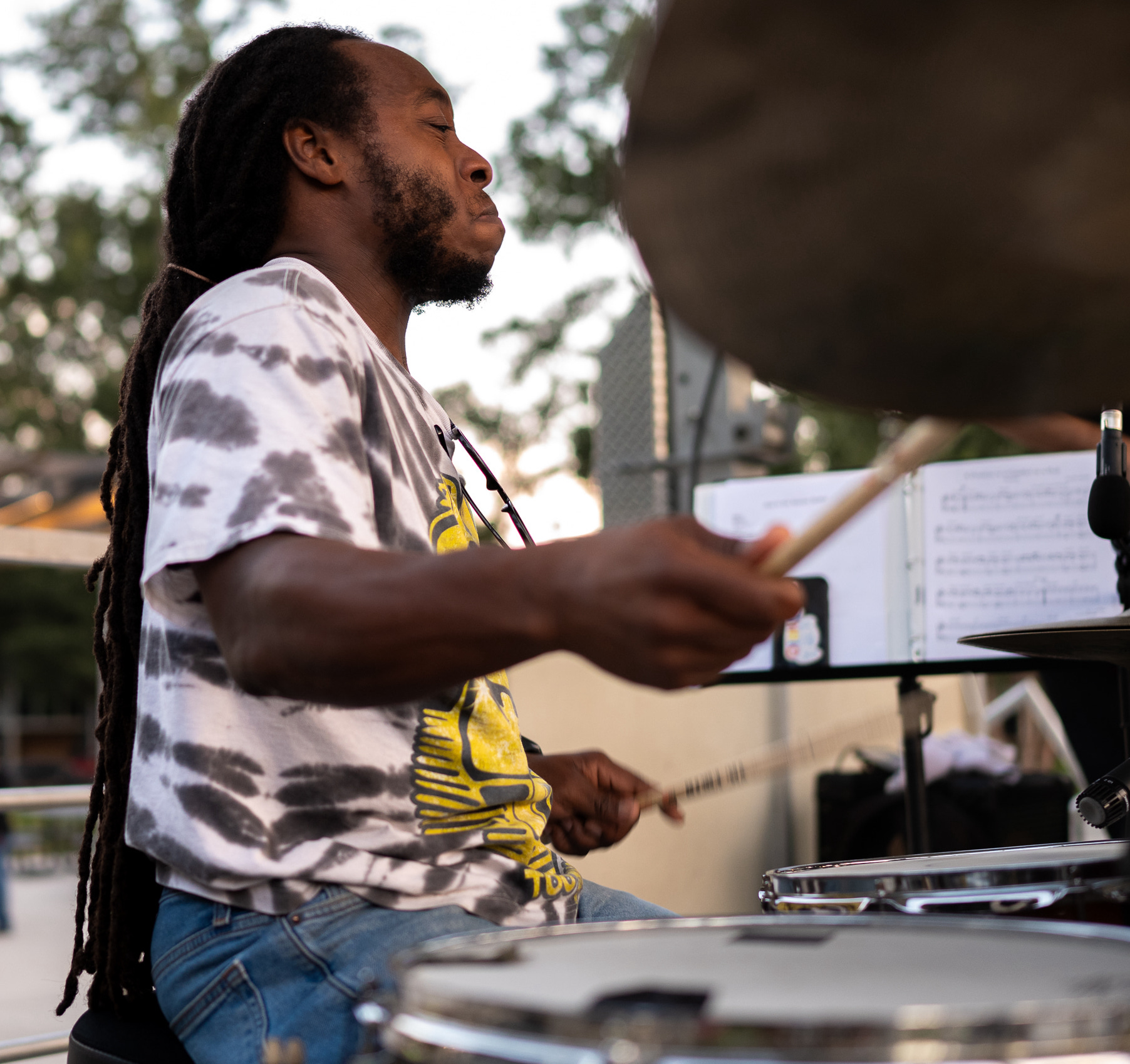 Adult musician playing drums during a lesson
