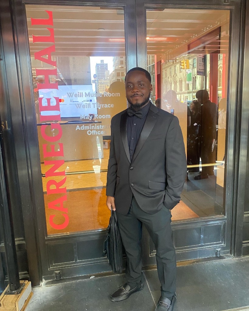 Josh Mickens in formal attire outside Carnegie Hall