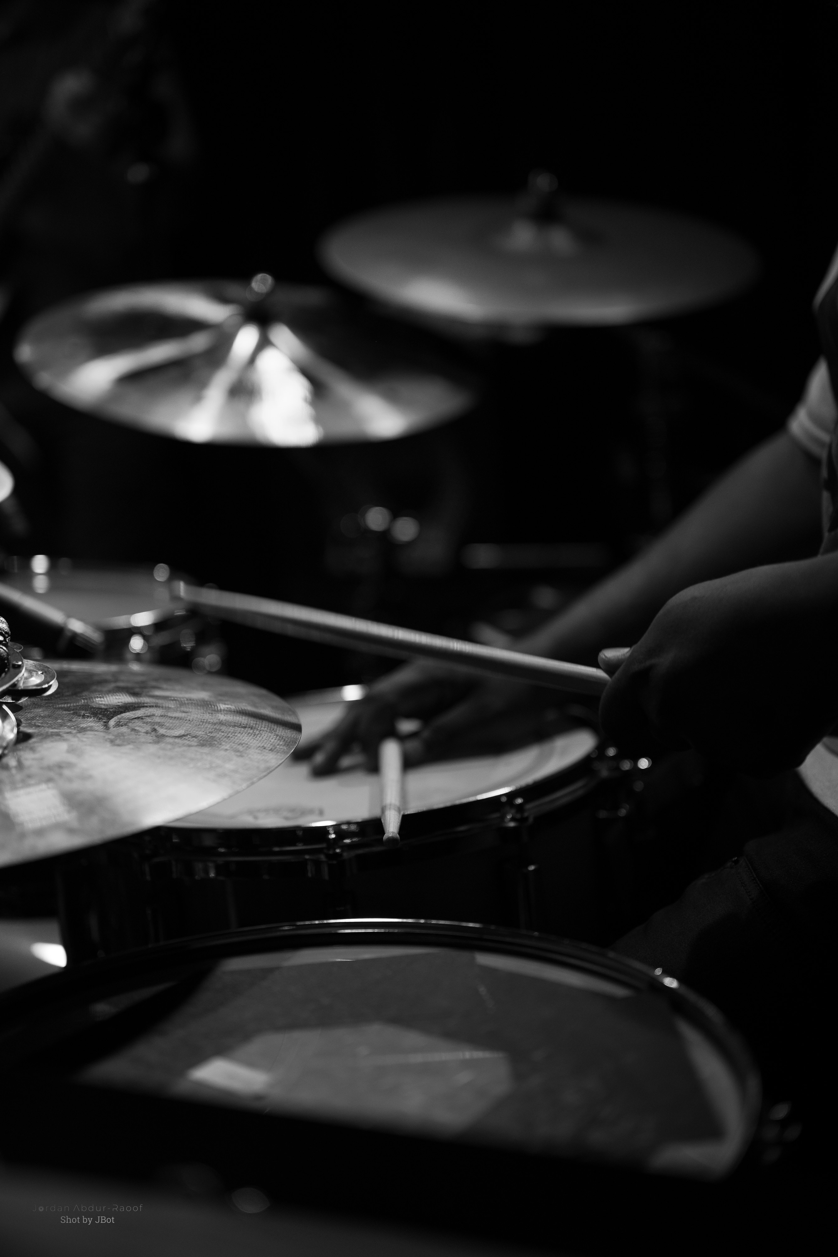 Student playing drums during a music lesson